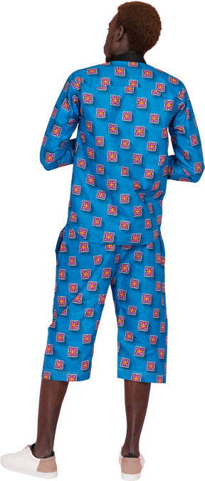 Black man in blue pajamas standing